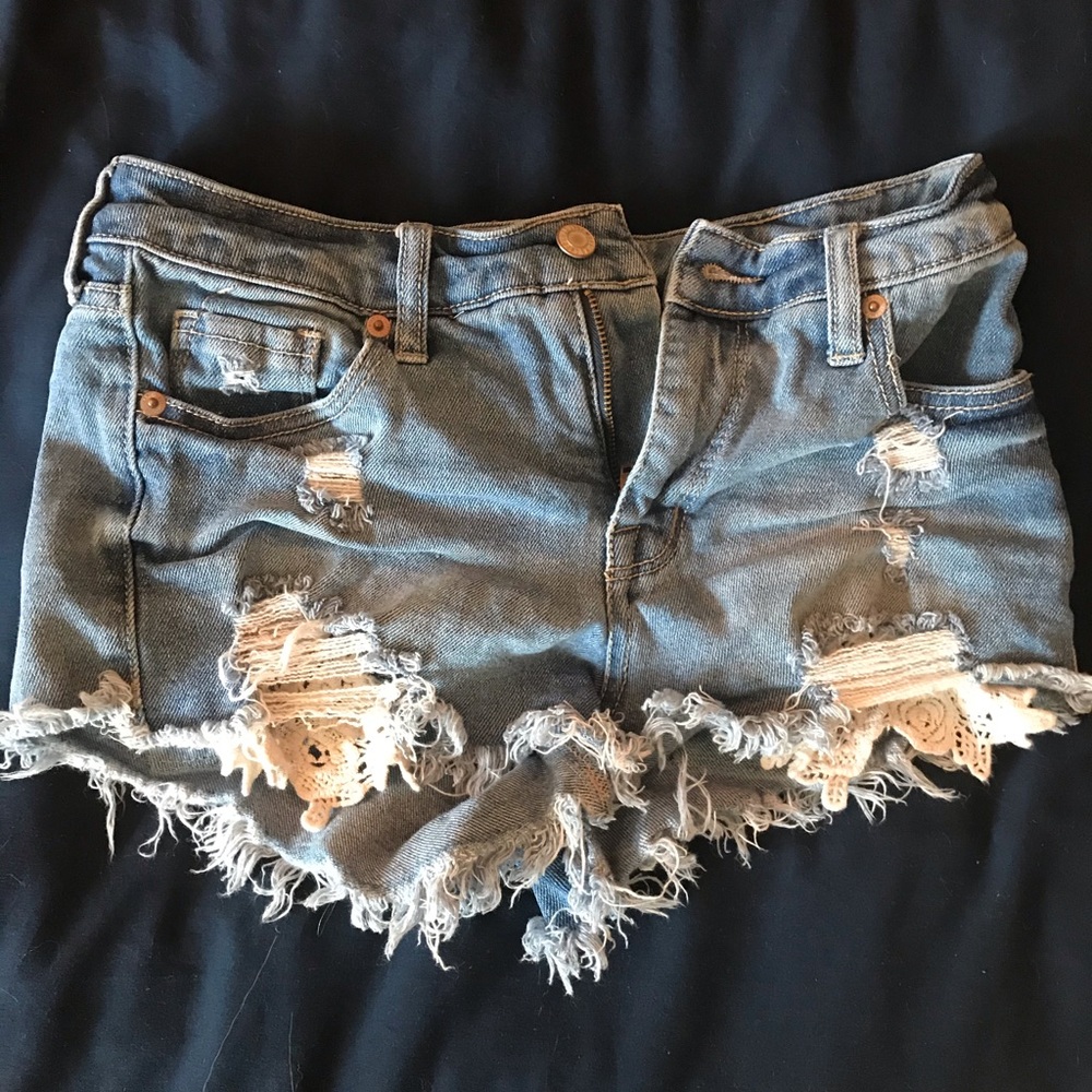 distressed jean shorts with lace pockets